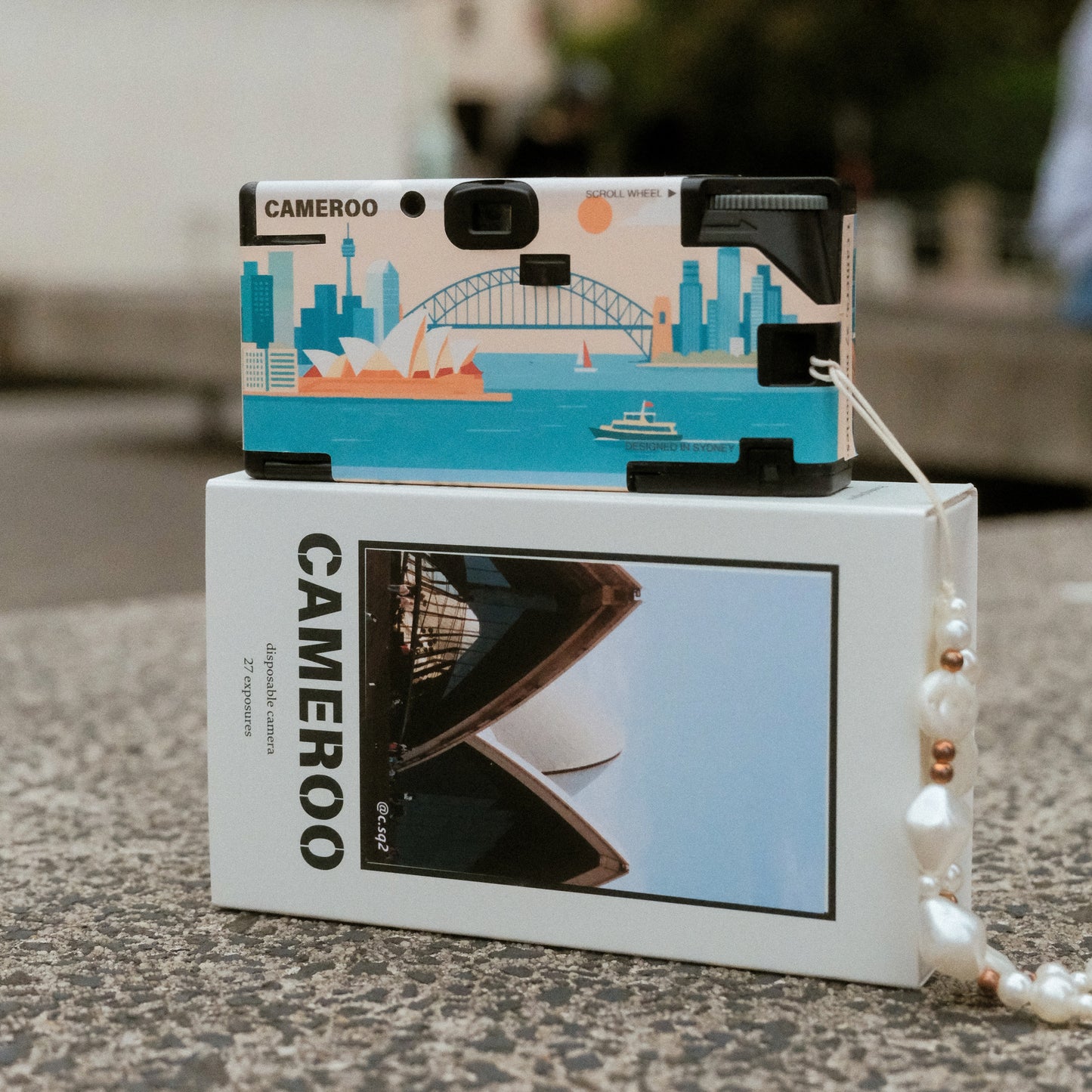 Back view of Cameroo disposable camera with Sydney Opera House and Harbour Bridge design. Packaging box with local australian film photography.